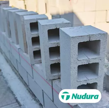 Concrete blocks stacked on a construction site. Logo of 